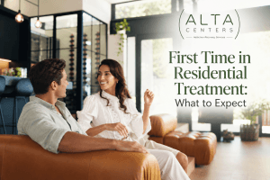 A man and woman talking on a sofa in a bright, calm lounge, reflecting what to expect during a first time in residential treatment at Alta Centers.